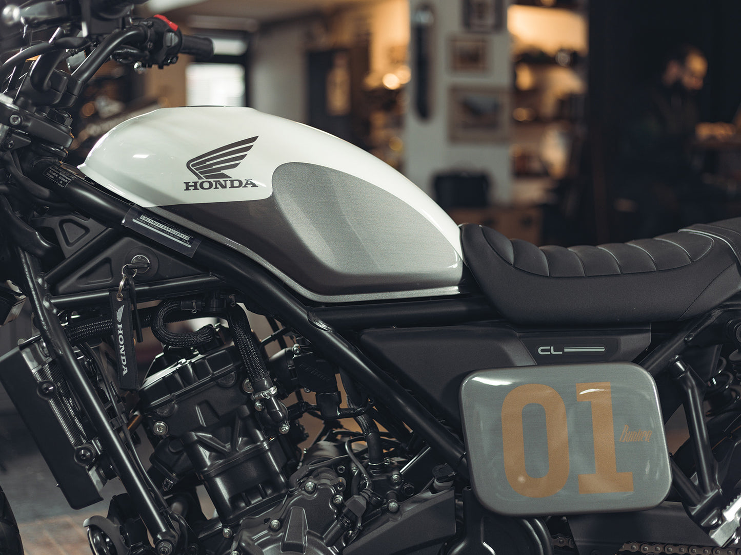 Black rectangular Honda CL250 CL500 Number Plate Side Cover with '01' printed on it, featuring a bunker logo, Glossy Metalic Grey Finish