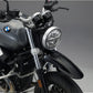 Close-up of a bmw r ninet headlight with a dark background custom front fender kit