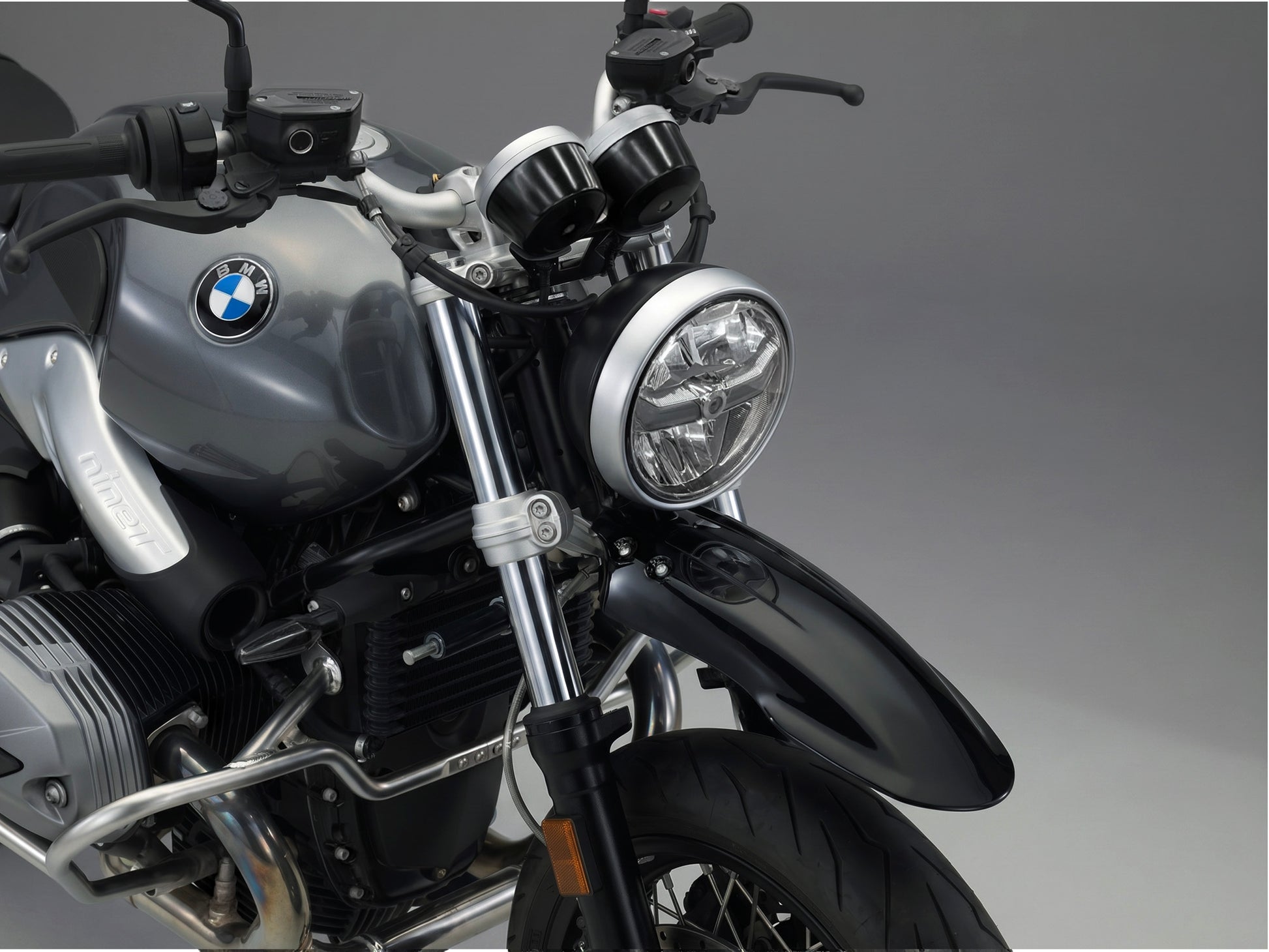 Close-up of a bmw r ninet headlight with a dark background custom front fender kit